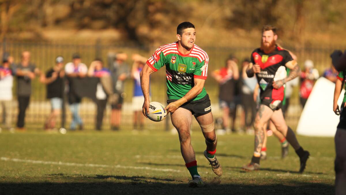 On the attack: Jamberoo's Mark Asquith spins the ball wide in the grand final against Kiama. Picture: David Hall