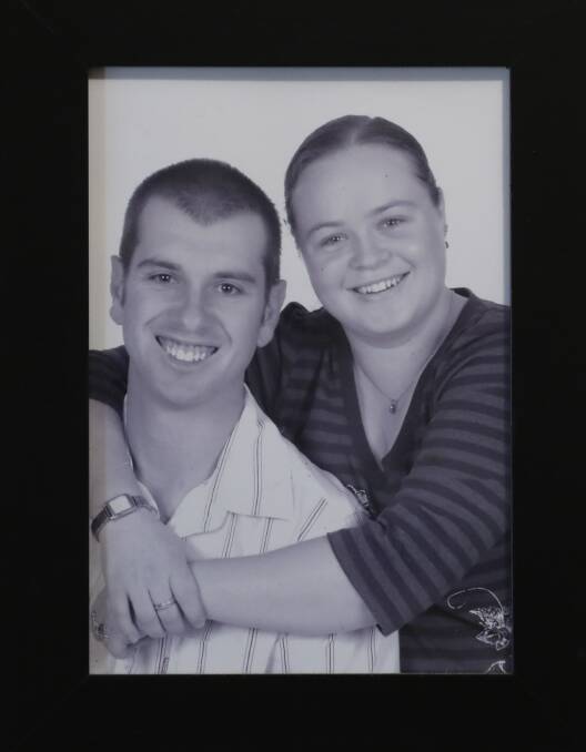 A picture hangs on the wall of a young Dan and Lisa.