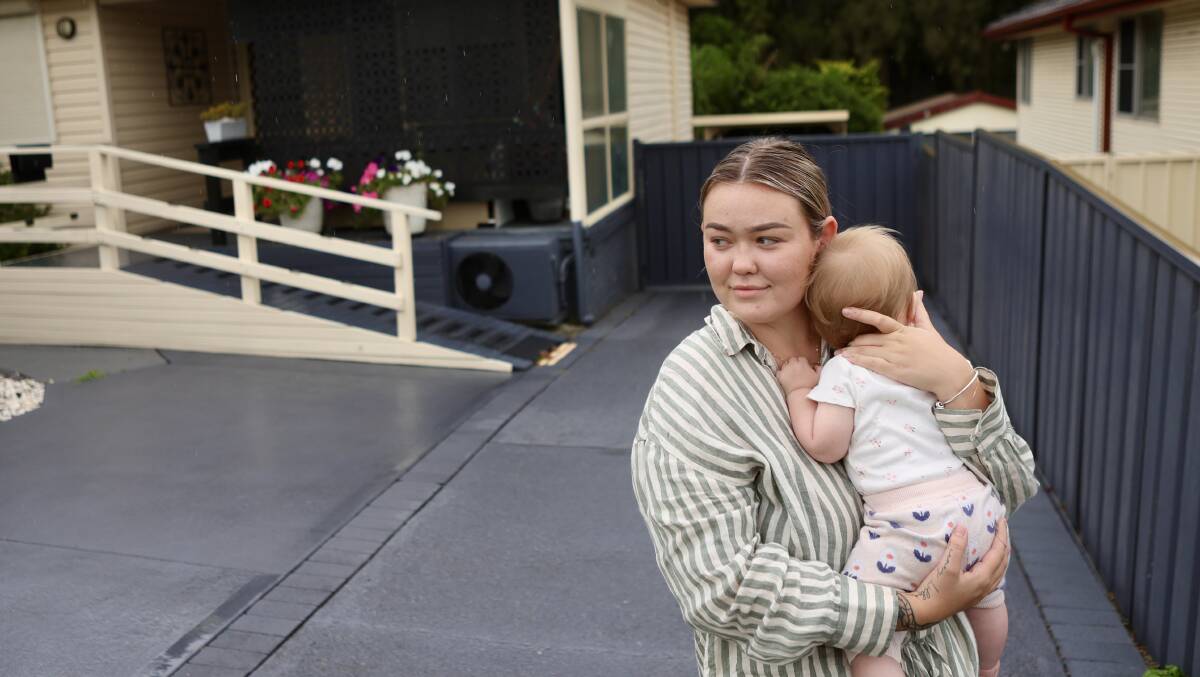 Tori Avnell and her daughter are pictured in the driveway of their home, where the family's stolen car was formerly parked. Picture: Adam McLean 