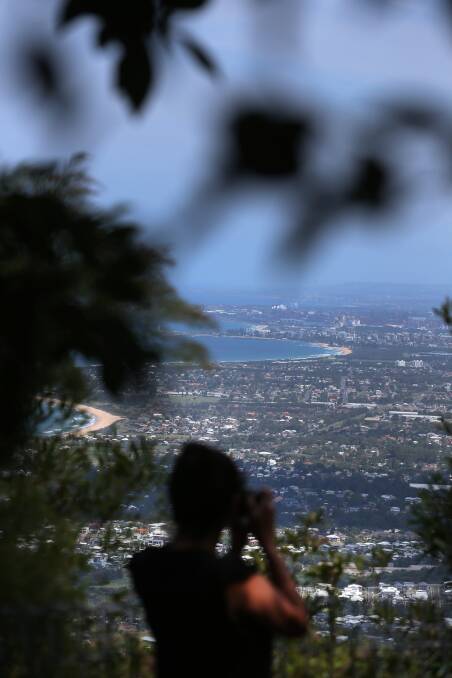 CAPTURING BEAUTY: Gongspotting founder Roz takes a photo of Wollongong from Sublime Point. Her Instagram page has almost 6000 followers. Picture: Robert Peet