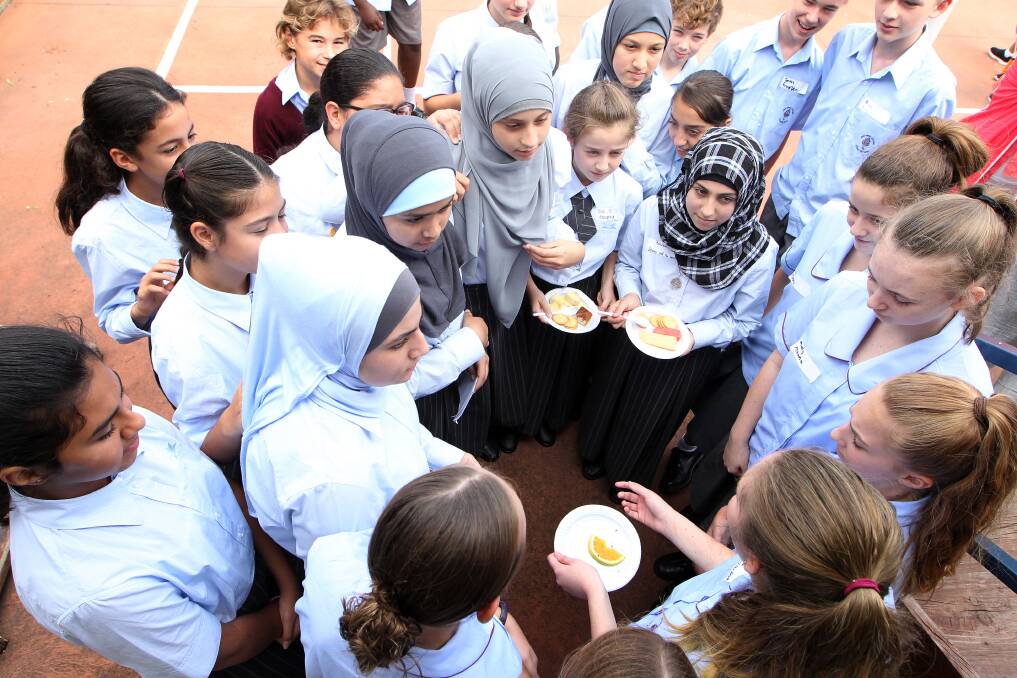 A SHARED CELEBRATION: Amity College Illawarra students and Holy Spirit College students enjoyed food and other activities together. Picture: Sylvia Liber