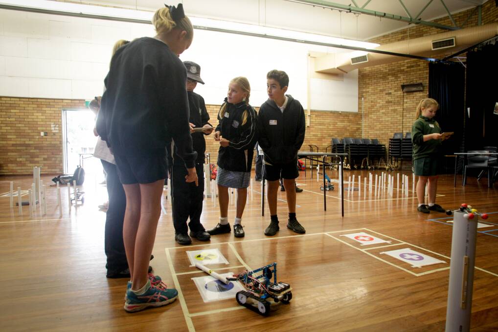 ROBOT TESTING: Wollongong Public School students taking part in the STEM Tournament at Keira High School on Friday. Picture: Georgia Matts