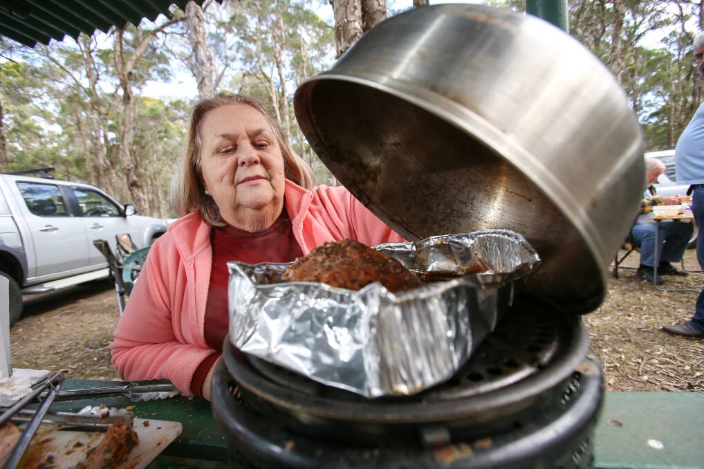 KEEN EYE: Albion Park Outdoor Camp Kitchen Challenge judge Marilyn Connelly checks the roast pork cooking on a South Africian Cobb cooker. Picture: Adam McLean.