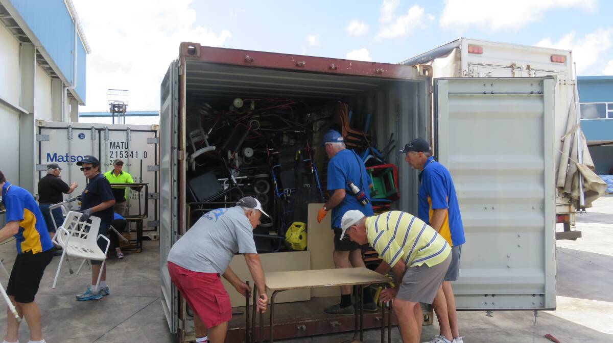 Mission accomplished: Members of the West Wollongong Rotary Club unload the container of donated goods on the island of Rarotonga.