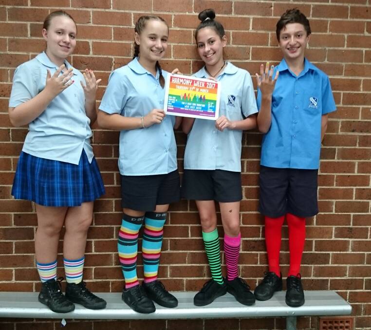 Celebrating diversity: Keira High School students Erica Domazet, Yr 8; Isabella Popaski, Yr 7; Zara Costanzo, Yr 10; and Ethan Lowe, Yr 7, wore bright socks and had their nails painted to raise funds for a mentoring program. 