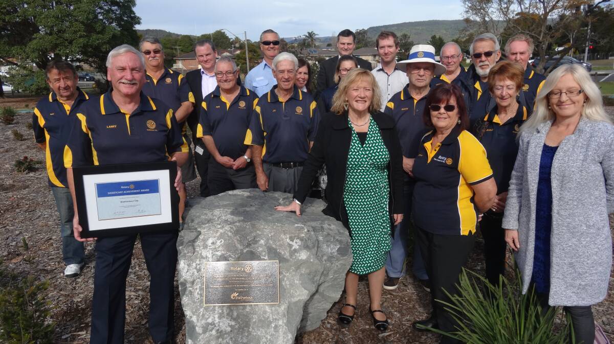 50th celebration: Members of Shellharbour City Rotary Club join council representatives at the commemorative garden and plaque in Rotary Park, in front of Albion Park Railway Station.