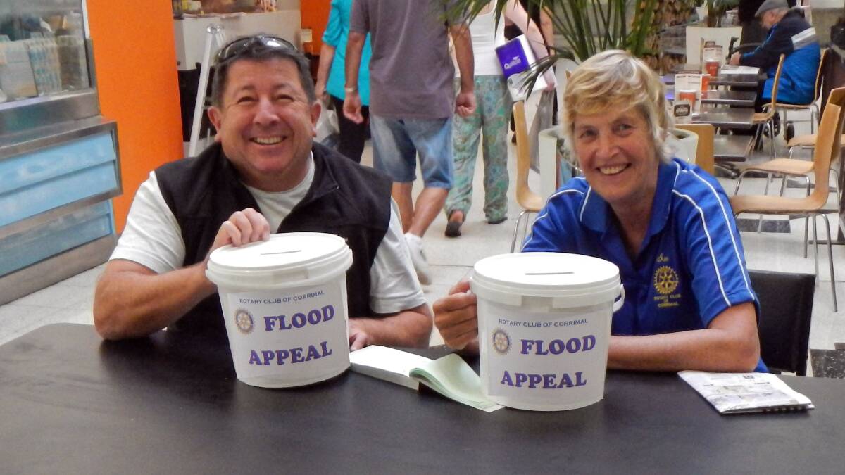 Helping hand: Rotary Club of Corrimal Past President Stephen Knightley and President Elect Sue Clark with their flood appeal fund-raising buckets at Stockland Corrimal.