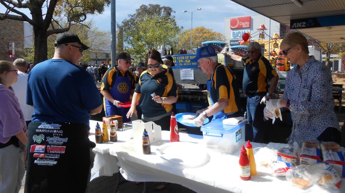 Sausage sizzle: Twelve members of Dapto Rotary Club manned the barbecue at the Father's Day Dapto Street Fair. Proceeds will go to community projects around Dapto.