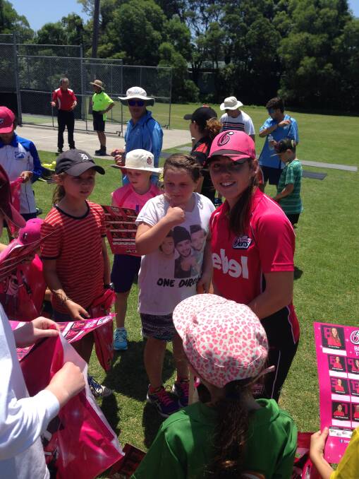 FUN: Womens’s Big Bash League Sydney Sixers player  Jodie Hicks with some girls at the school holiday clinic at Figtree Oval. 