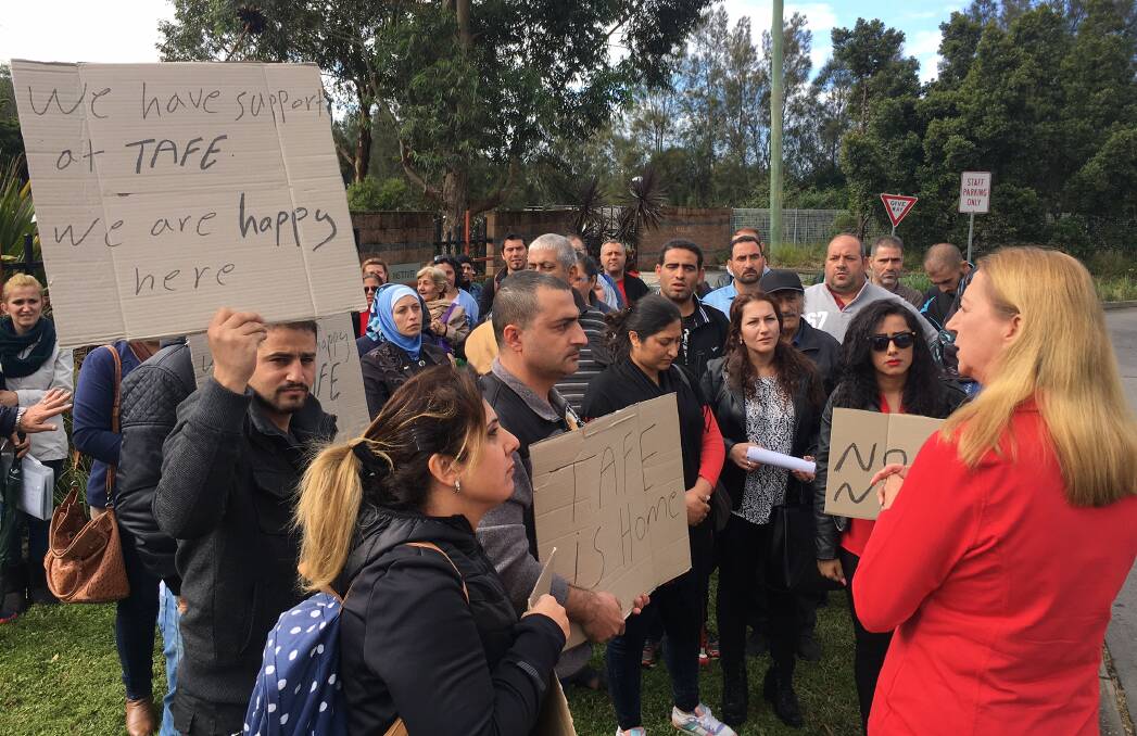 NOT HAPPY: English language students protesting at Wollongong TAFE in early May. They are disappointed TAFE has lost its funding to run the AMEP course. The decision has been slammed by Labor and the Greens.
