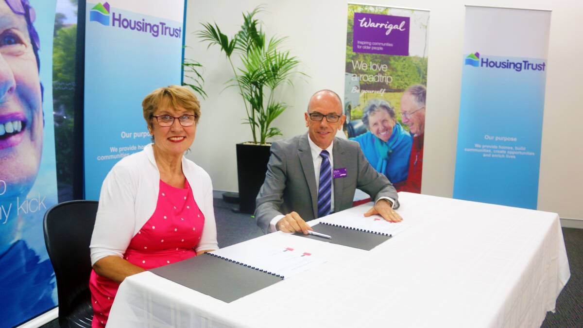 PARTNERSHIP: The Housing Trust CEO Joan Ferguson and Warrigal CEO Mark Sewell sign a Memorandum of Understanding to help them shape service delivery for older people in community housing around the Illawarra. Picture: Supplied.  