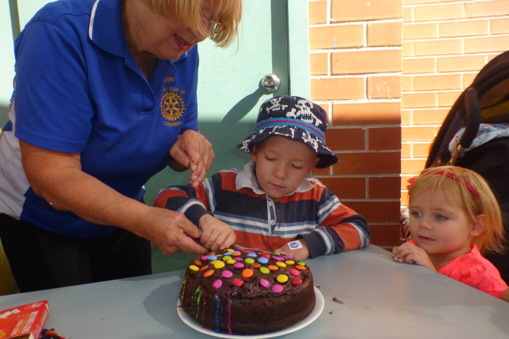 CELEBRATE: Imagination Library Illawarra staff and children cut the birthday cake.

