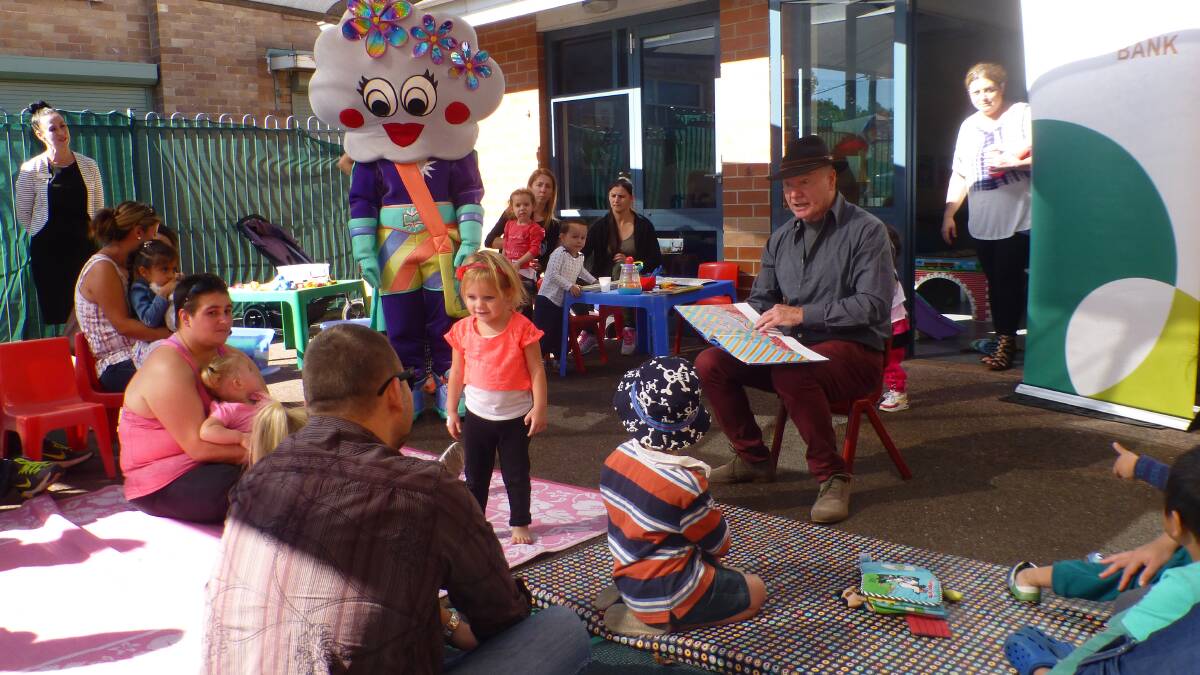 STORY TIME: Wollongong Lord Mayor Gordon Bradbery reads to kids during the birthday celebrations.
