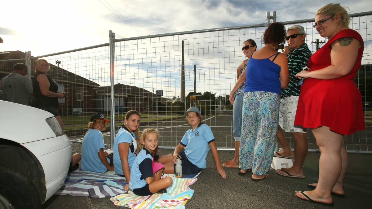 Early morning arrivals Cody, Tyra, Holly and Blair sit at the barrier fence on Military Road. Picture: KIRK GILMOUR