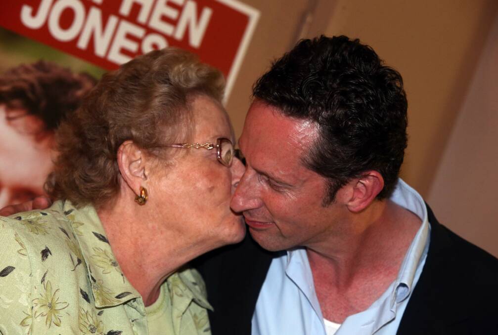 Throsby MP Stephen Jones gets a kiss from his mother Margaret at his election night function at Oak Flats Bowling Club. 