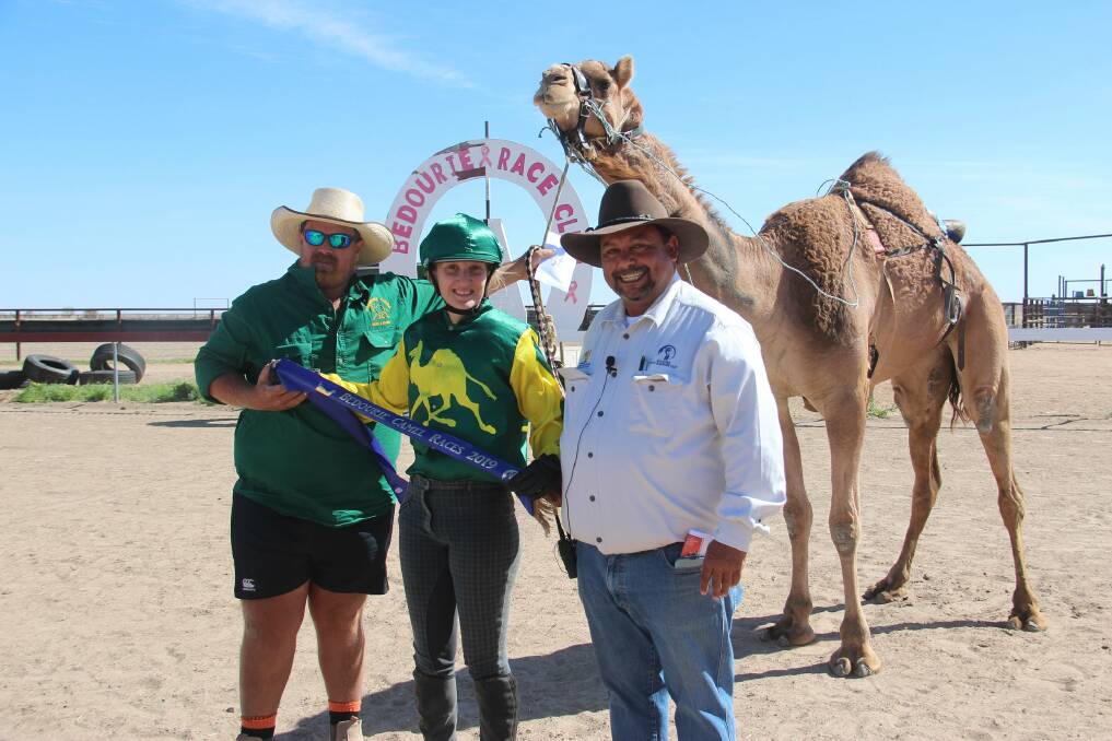 Trevor "Colgate" Stewart (right) presents the blue ribbon to one of the winners at Bedourie Camel Races.Photo: Shelly Dillon.