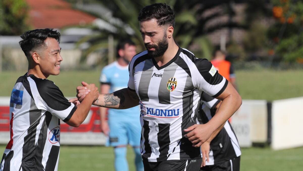 Oli Carrasco (right) celebrates with a Port Kembla teammate after scoring a goal last year. Picture by Robert Peet