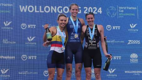 Saturday's elite women's race winner Tilda Mansson, of Sweden, (centre) celebrates on the podium with Colombia's Maria Carolina Velasquez and New Zealand's Ainsley Thorpe. Picture by Sylvia Liber