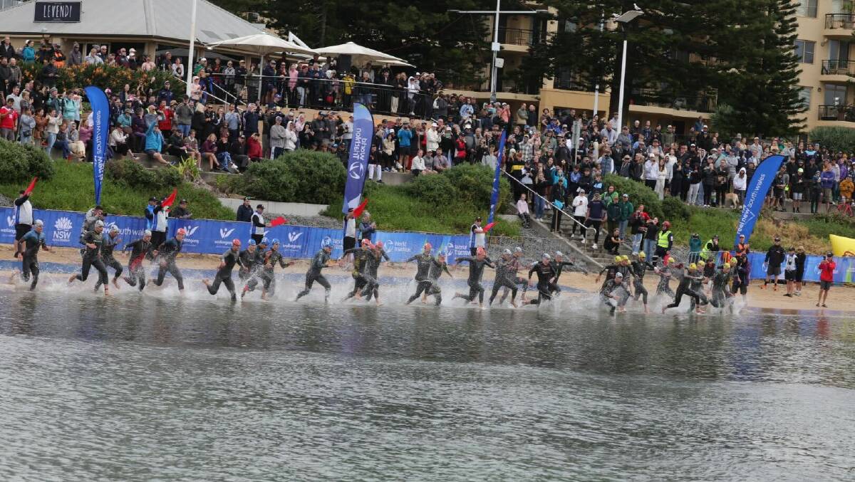 Elite men's race competitors enter the water in Wollongong Harbour for the first leg of Saturday's event. Picture by Sylvia Liber