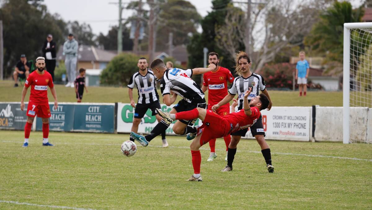 Port Kembla and United players scrap for possession at Wetherall Park. Picture by Anna Warr