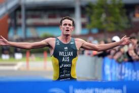 Australia's Luke Willian raises his arms in triumph as he prepares to win the elite men's race at Saturday's World Triathlon Cup in Wollongong. Picture by Sylvia Liber
