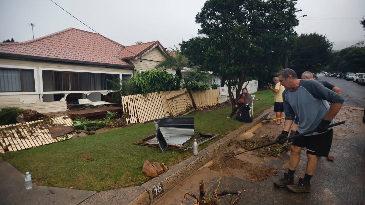The clean-up begins at Gary and Bronwyn Hart's home, after a terrifying morning when floodwater raged through their house. Picture by Anna Warr