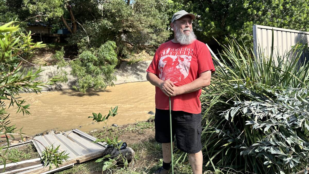 Paul Harrison stands in his backyard, where the fence has been ripped down into Byarong Creek. Picture by Kate McIlwain