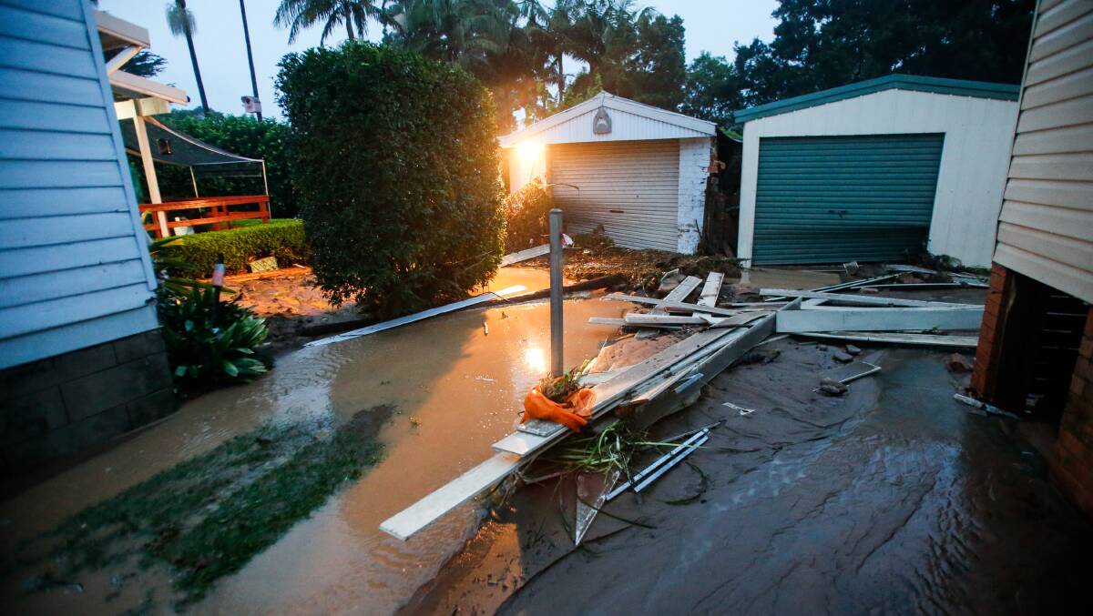 Gary and Bronwyn Hart's house (right) had a river of mud flow through it, destroying everything in its path. Picture by Anna Warr
