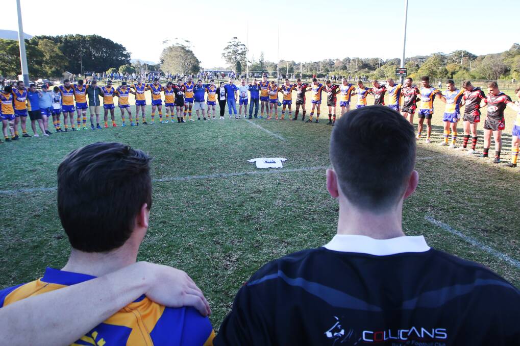 TRIBUTE: Dapto and Collegians players unite in a minute's silence for Tory Brunning. Picture: Sylvia Liber.