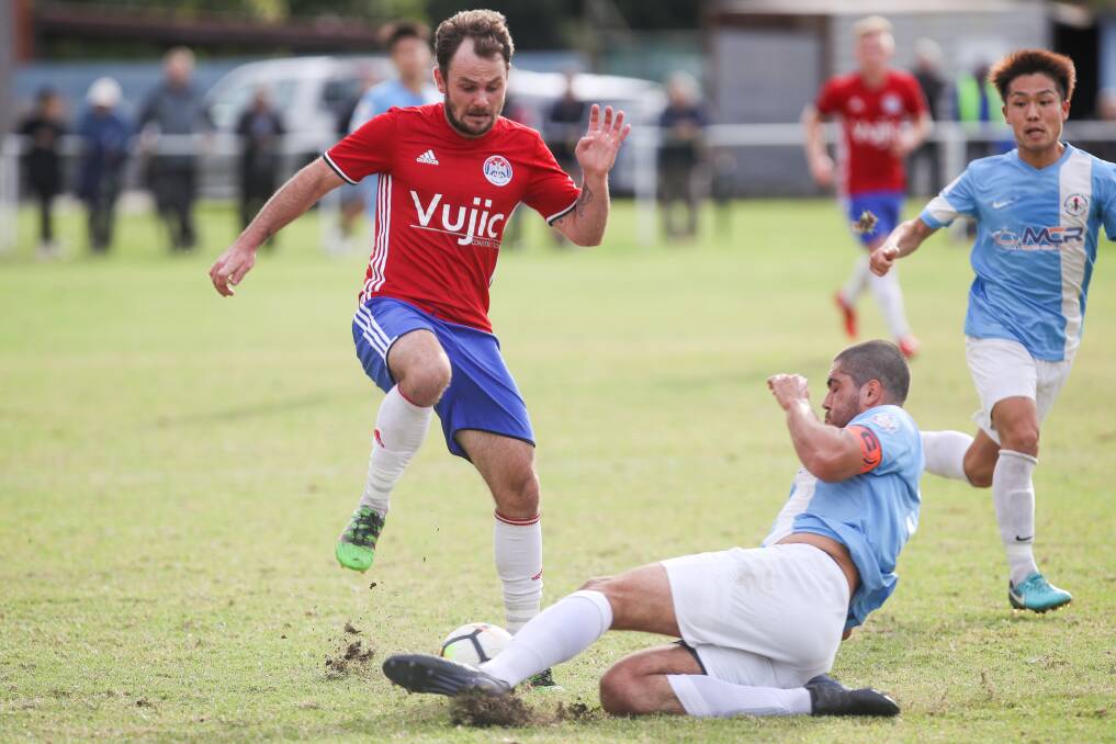 MISSED CHANCE: Olympic defender Jake Duczynski makes a sliding challenge against Albion Park White Eagles. Picture: ADAM McLEAN