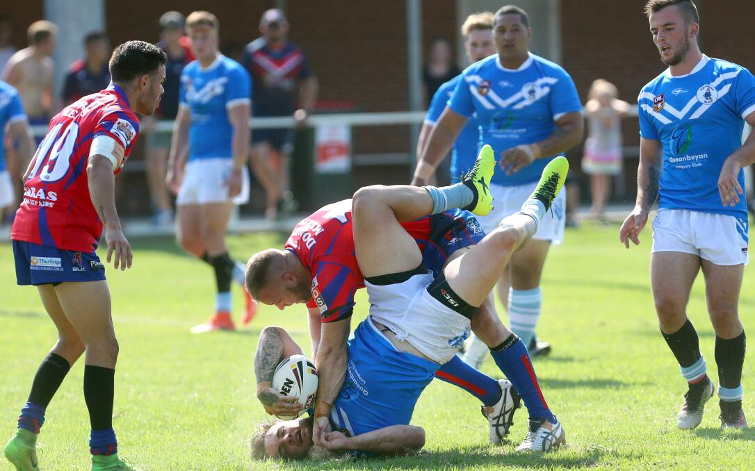 ROUGH STUFF: Devils back-rower Kyle Lodge wrestles Blues forward Josh Stuckey to the Parrish Park turf. Pictures: Sylvia Liber