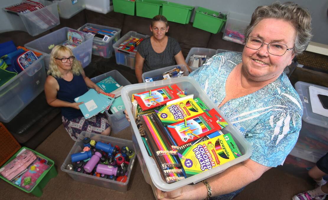 PAYING IT FORWARD: Karyn Lewis, Sharon Jolliffe and Janet Hoppo with some of the supplies for the school stationary packs. Picture: Robert Peet