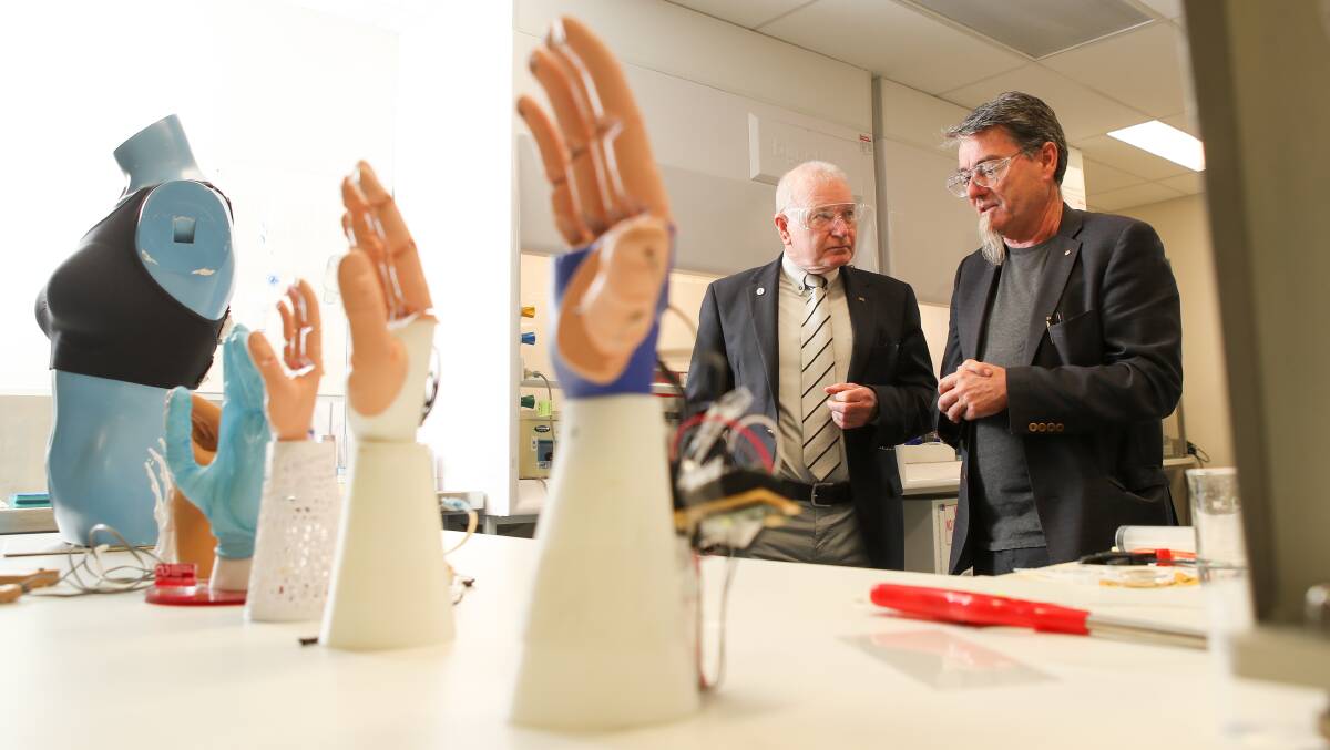 HANDS UP FOR SCIENCE: Wollongong Lord Mayor Gordon Bradbery with  Professor Gordon Wallace. Picture: Adam McLean 