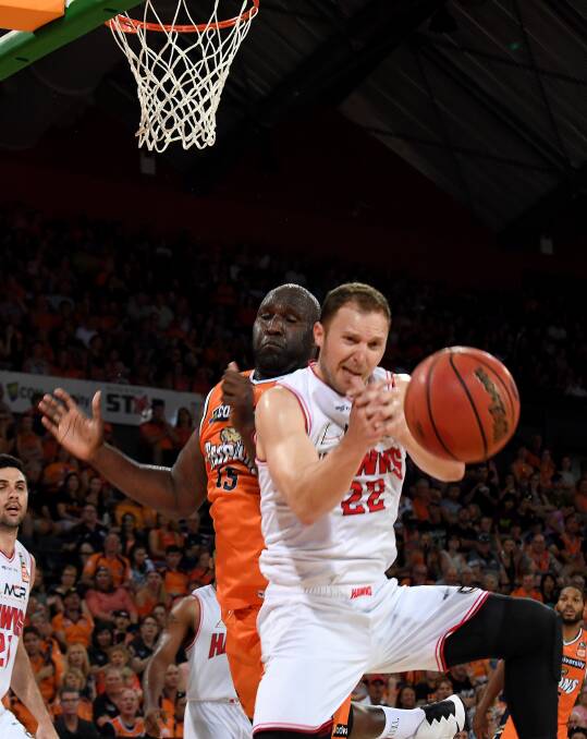 ROUGHING IT: Hawks veteran Tim Coenraad battles under the basket with Taipans centre Nat Jawai on Sunday. Picture: AAP
