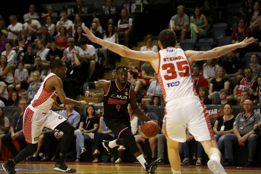 ON THE FLOOR: Hawks guard Cedric Jackson takes on Perth's Bryce Cotton at WIN Entertainment Centre. Picture: SYLVIA LIBER