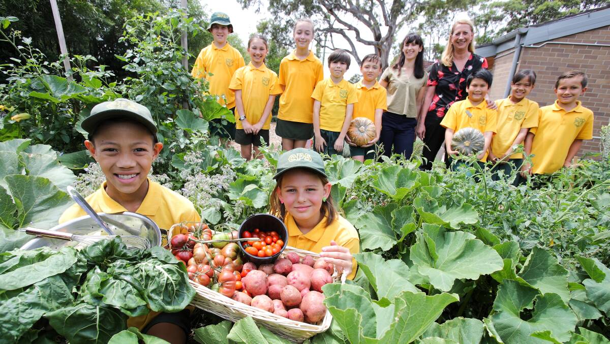 GARDENERS: Kal-El Rosales and Saffron Smith with fellow Coniston Public School students and teacher Kate Perini and Cunningham MP Sharon Bird. Picture: Adam McLean