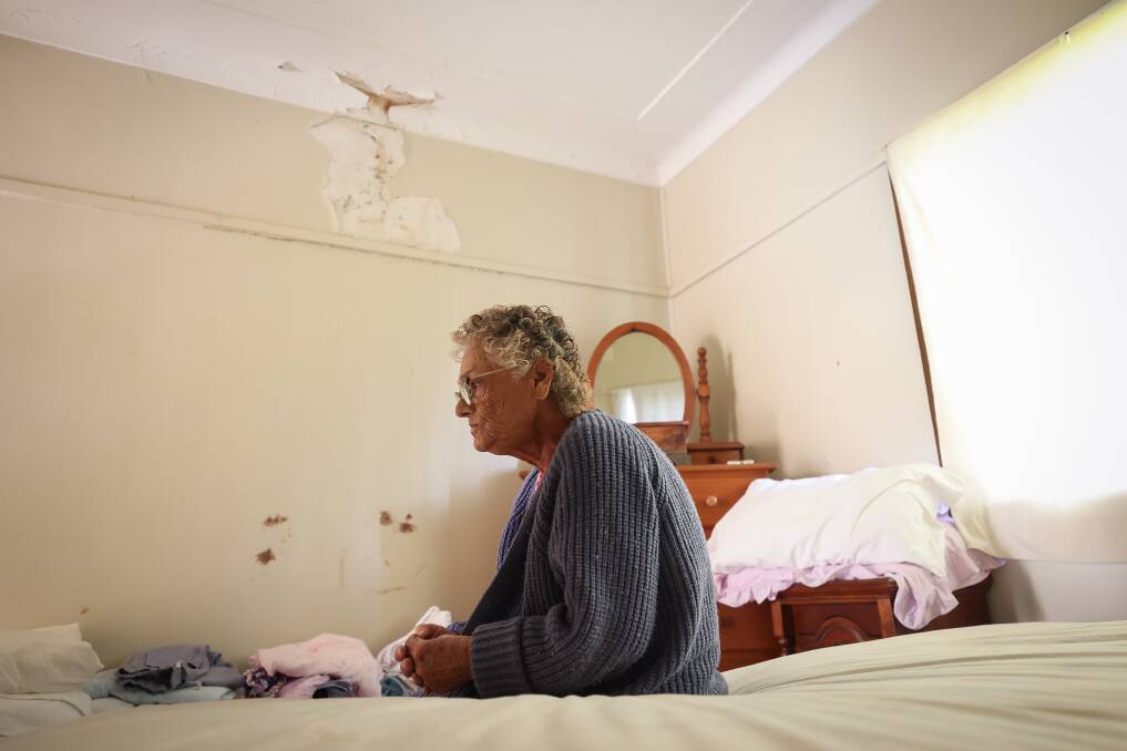 Judit Hajner in her bedroom, with the peeling paint and mould visible. Picture by Adam McLean