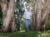Penny Hoswell standing among the trees of Wollongong Botanic Garden. Picture by Sylvia Liber