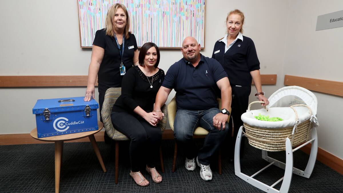 Donation: Wollongong Private Hospital maternity services manager Julie Walsh and midwife Leanne Wallace with Vicky and James Maiorca and the cuddle cot they have gifted for other grieving parents. Picture: Sylvia Liber