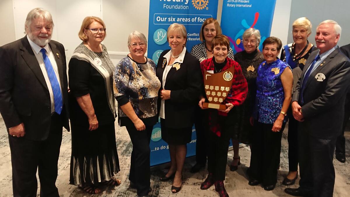 Brian Ashe, Illawarra Sunrise; Tonia Barnes, Kiama; Kay Mireylees, District Governor Sue Hayward; Julie Collareda, Dapto; Helen Hasan, West Wollongong; District Governor Elect, Di North; Sue Clark, Corrimal; Larry How, Shellharbour City; in front Dot Hennessy holding plaque.