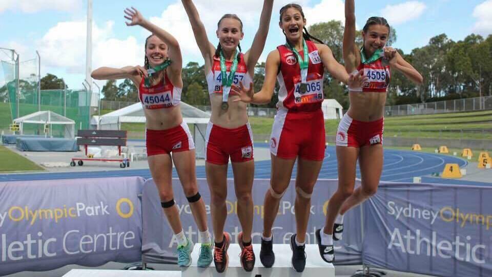 Relay win: The Wollongong  U15 girls celebrate their win in the 4x100m event -  Janna Hadaya, Grace Adams, Hannah Crinnion and Alyssa Parks.