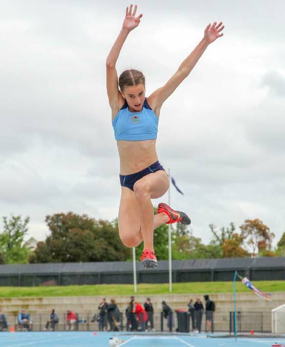 High flyer: Delta Amidzovski in mid-flight during a long jump. She established a new NSW record of 5.58m. File Picture: Sportstrend Photo