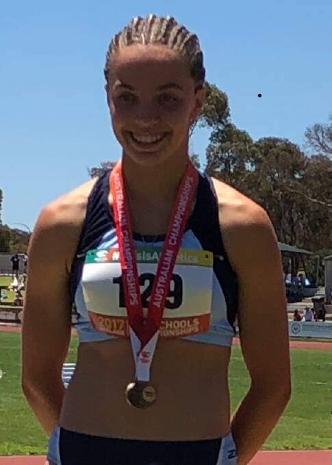 Gold medal: Grace Adams, from Corpus Christi High School, Oak Flats, won the girls under 16 90m hurdles at the All Schools Australian Championships in Adelaide.
