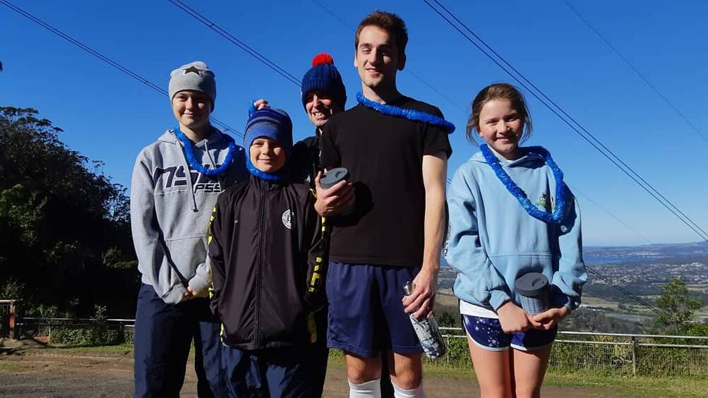 Running royalty: King of the Mountain Christopher Thurbon shares with Queen of the mountain Imogen Anderson and Prince of the Mountain Joshua Smith and sister Charlotte Smith who took out the Princess of the Mountain in blustery, windy and cold conditions on Mt Kembla on Sunday.