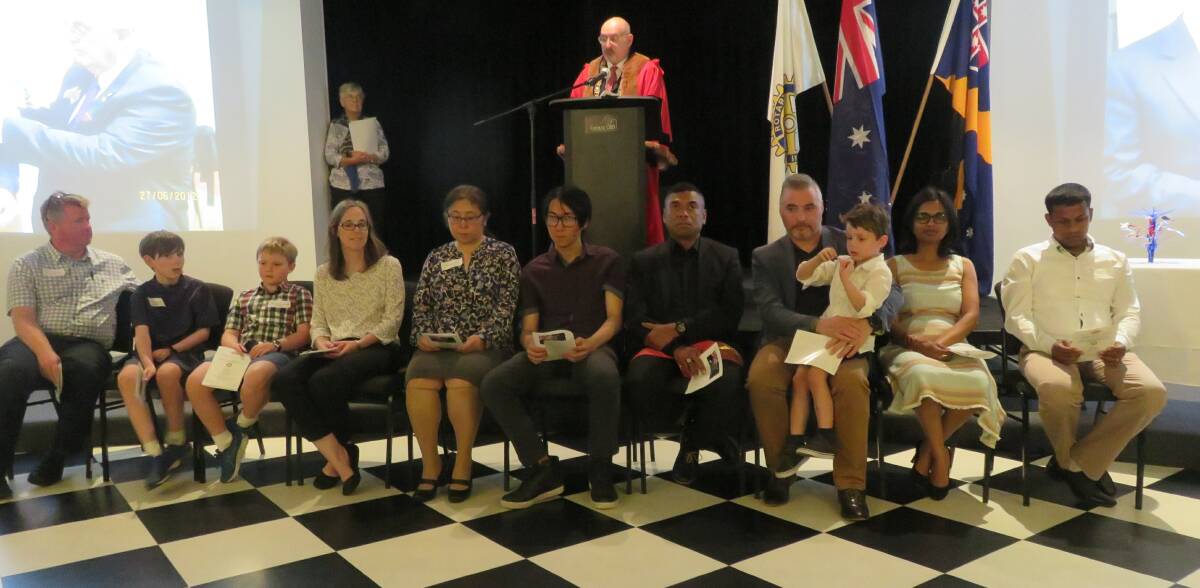 Brand new Aussies: Deputy Lord Mayor David Brown presides over the citizenship ceremony with West Wollongong Rotary Club's Helen Hasan.