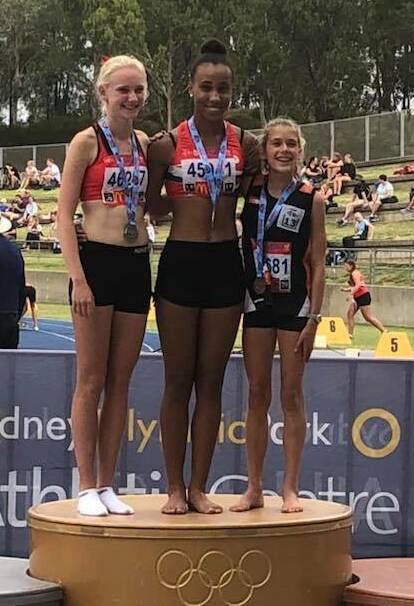 Speed queen: Athletics Wollongong junior athlete Chelsea Ezeoke (centre) won three gold - in the U14 400m, the U14 100m and the U14 200m at the state titles. 