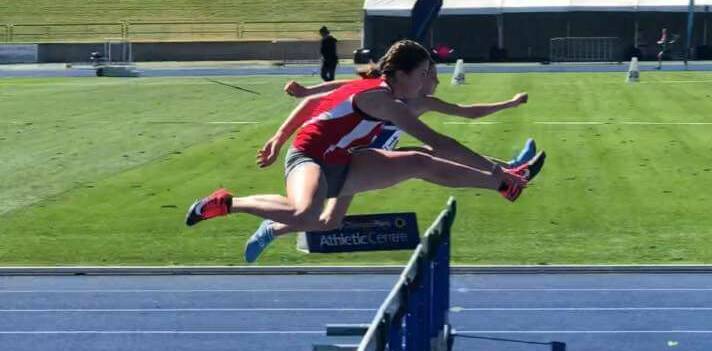Going for gold: Ashlyn Adams going stride for stride at Combined Catholic Colleges before going on to take gold in the 90m hurdles.