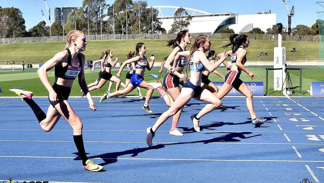 Blue Star: Emma Matthews (in lane second closest to camera) flashes home to take the silver medal in the girls' 15 years 100m. She's now off to the Australian All Schools.