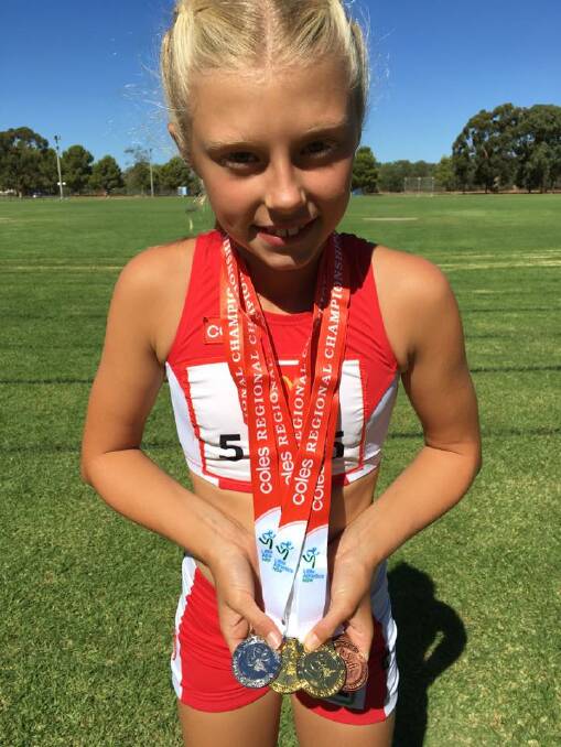 Medal haul: Kaitlyn Williams with medals won in the girls under 11 category at the Region 4 Track and Field Championships in Griffith.