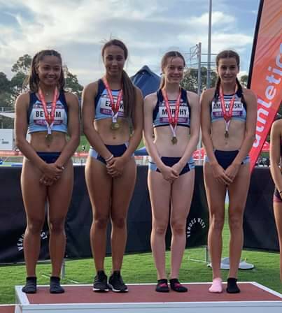 Chelsea takes to the podium with the state team including local Delta Amidzovski after winning the Australian 14yrs 4x100m relay.